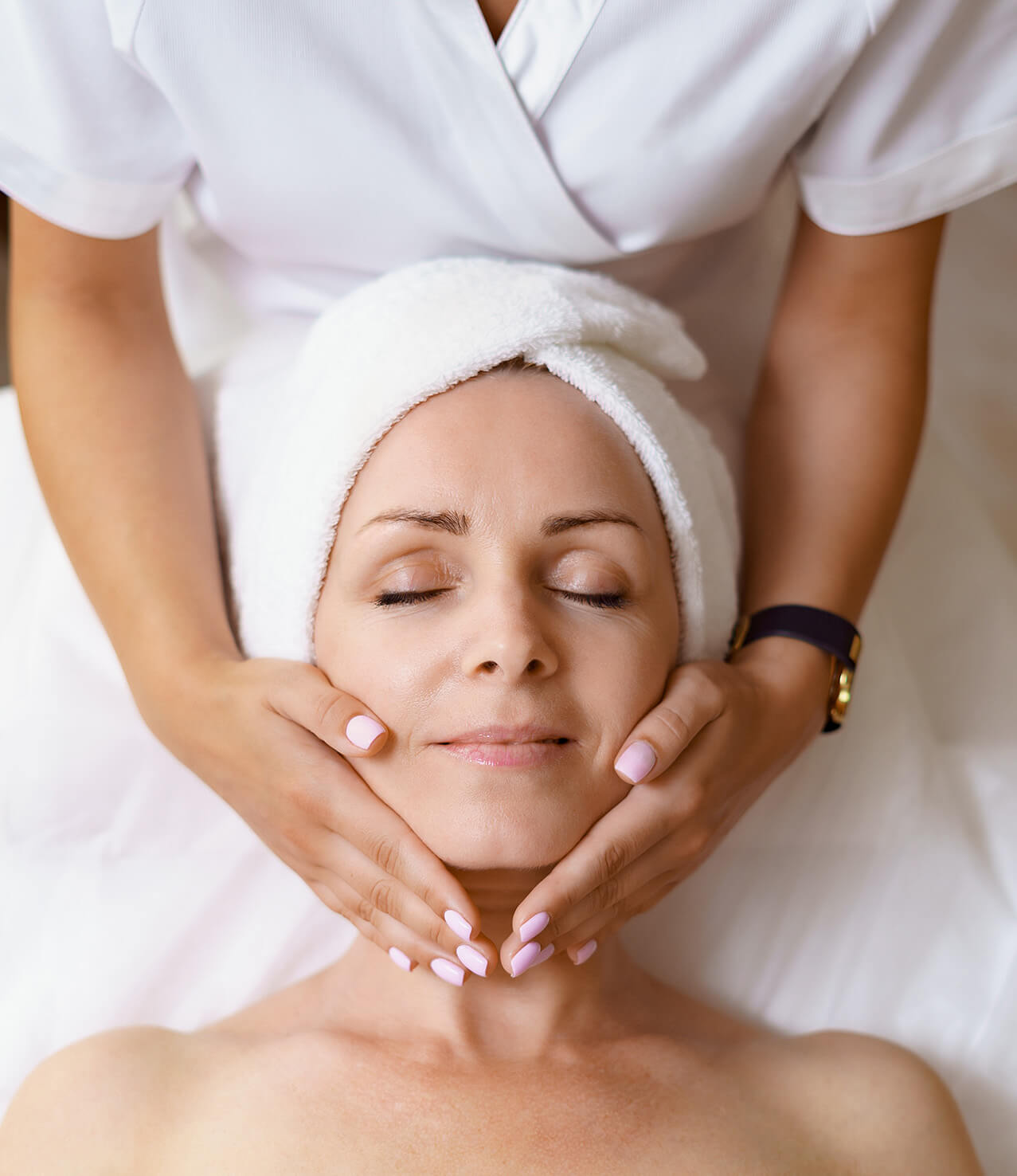 Ariel view of a woman receiving a facial massage