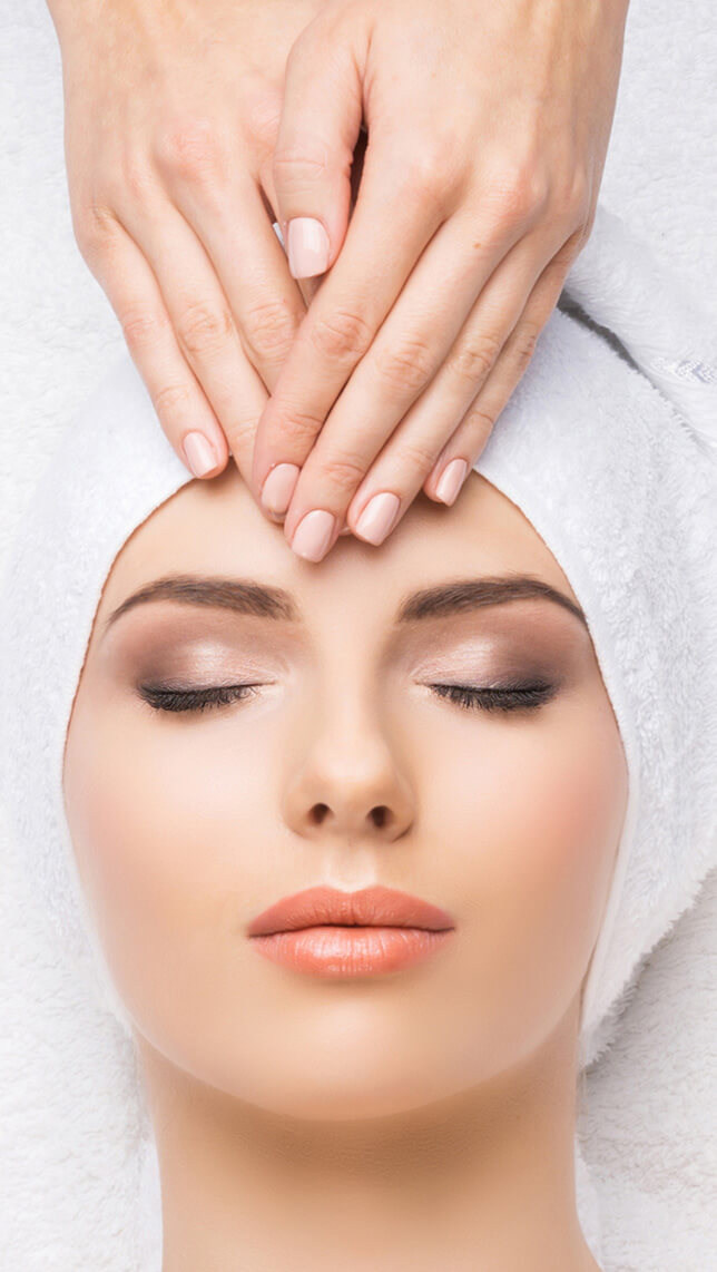 Aerial view of a woman having her forehead massaged