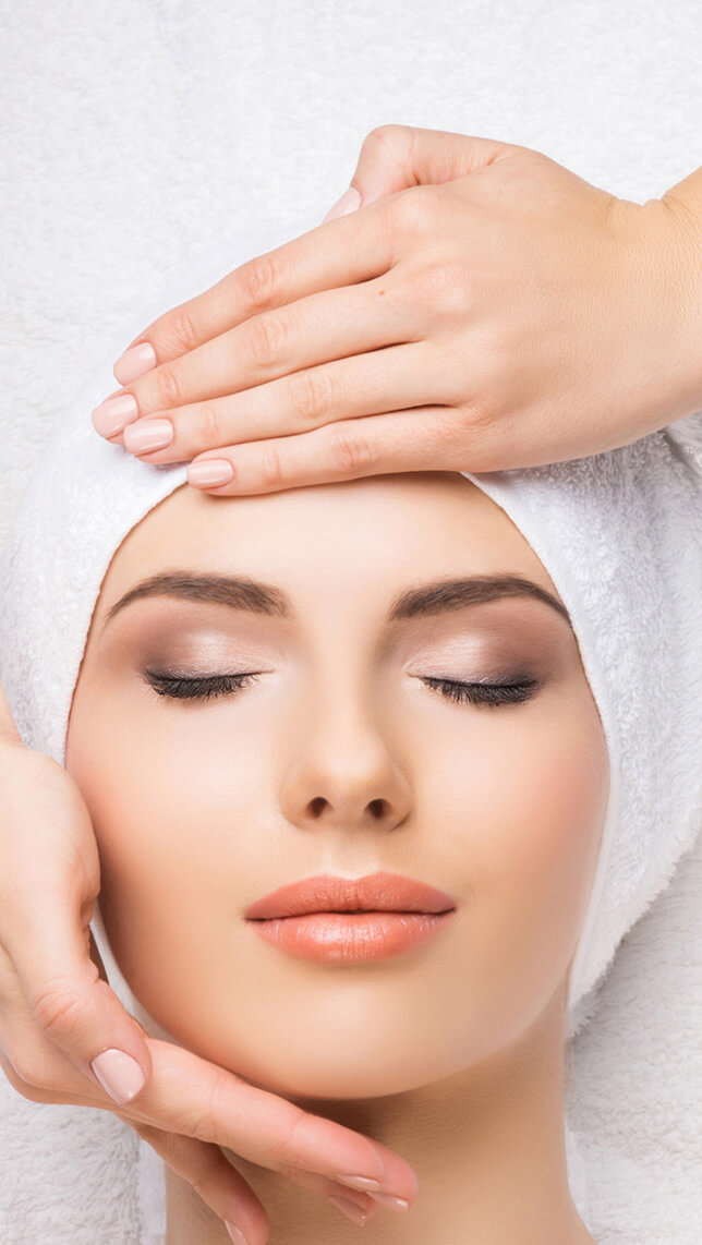 Aerial view of a woman having her forehead and chin massaged